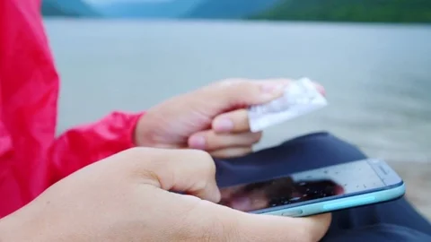 Close up hands holding credit card and using mobile smart phone outdoor. Stock Footage