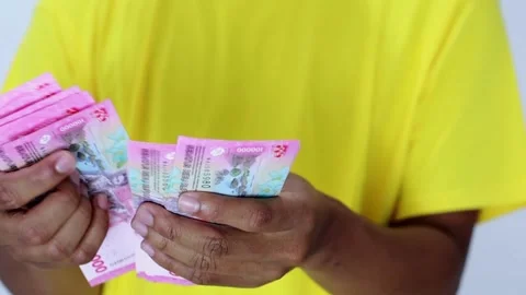 Close Up Hands Holding Currency Banknotes Against Yellow Shirt Stock Footage 307048141