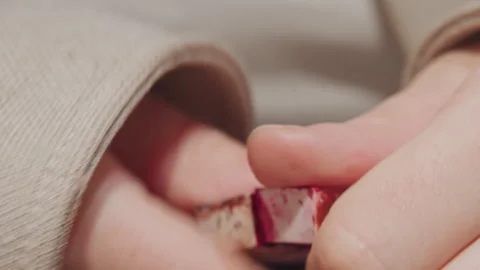 Close up hands holding examining detailed texture miniature red pink objects Stock Footage 345068635