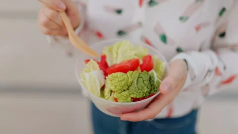 Close up of hands holding fresh vegetable salad bowl outdoors. Stock Footage 340587464