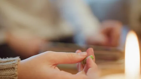 Close up hands holding green crayons with soft indoor lighting and blurred Stock Footage 346732073