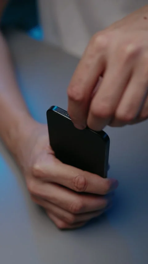 Close-up of hands holding mobile device and using specialized thin tool to Stock Footage 348066822