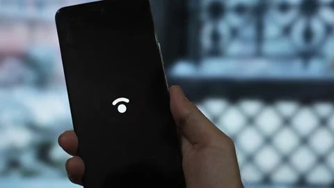 Close-up of hands holding a mobile phone showing a Wi-Fi error symbol agains Stock Footage 340510024