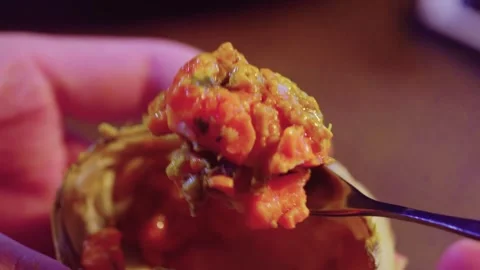 Close-up of Hands Holding Open Crab Shell with Roasted Meat Stockbeeldmateriaal 339070137