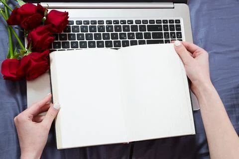 Close up - Hands holding an open notebook top view mock up. Topview on lapt.. Stock Photos