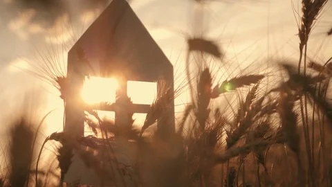 Close-up of hands holding a paper model at home in a field at sunset. Silhouette Stock-Footage 97073207
