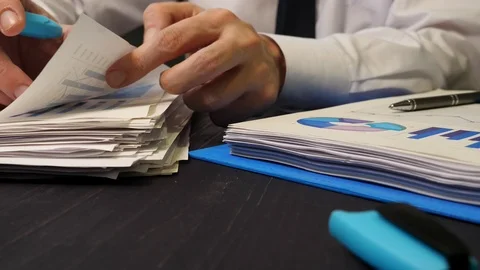 Close-up of hands holding papers. Office work with financial reports. Stock Footage 121810338