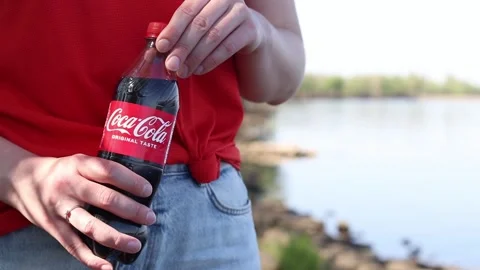 Close-up of hands holding a plastic bottle of Coca-Cola Original Taste Stock Footage 334792524