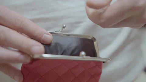 Close up of hands holding a red purse into which coins are tossed and close the Stock Footage 206136486