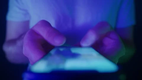 Close-up of hands holding a smartphone and scrolling Stock Footage 318960532