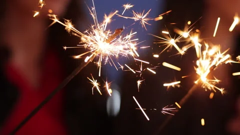 Close up hands holding sparklers group of friends celebrating waving sparkler Stock Footage 196005657