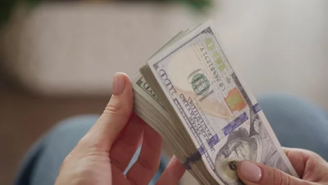 Close-Up of Hands Holding a Stack of Hundred Dollar Bills Stock Footage 280908558
