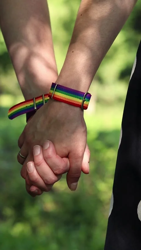 Close-up of hands holding together with pride symbols Stock Footage 341023778