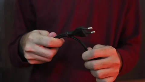 Close Up of Hands Holding Two Pin AC Power Cord Plug Stock-Footage 337847425