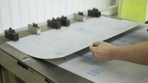 Close up hands hole puncher working inside printing house Stock Footage 71311997