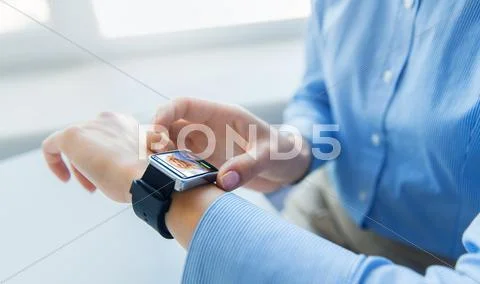 Close up of hands with incoming call on smartwatch Stock Photos