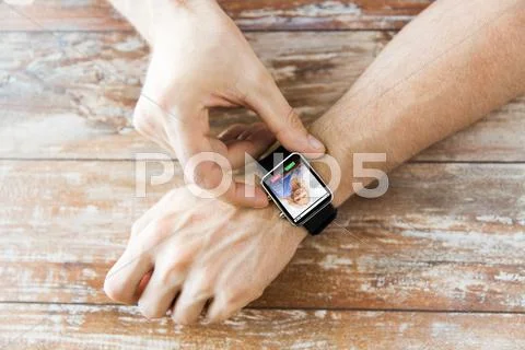 Close up of hands with incoming call on smartwatch Stock Photos