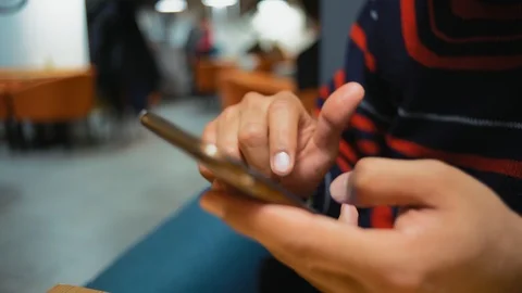 Close-Up, Hands of an Indian Guy Leafing Pages in a Smartphone Stock Footage 101661165