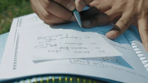 Close-Up,the Hands of an Indian Student with A Pen Recorded on a Sheet of Paper Stock Footage 111144016