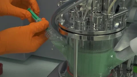 A Close up of hands injecting green liquid from machine Video stock 155535067
