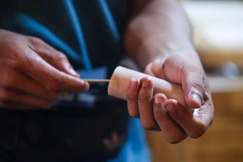 Close Up Hands Inserting Skewer Stick into Traditional Indonesian Es Potong.. Stock Photos