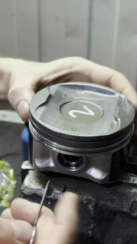 Close up of hands installing piston rings onto car engine. Stock Footage 332064796