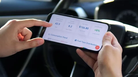 Close-up of hands interacting with a fuel spending app, analyzing total costs Stock-Footage 316807590