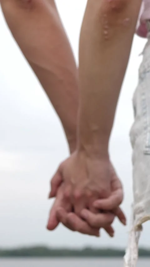 Close-up of hands joining together. A beautiful romantic moment between two Stock Footage 305215683