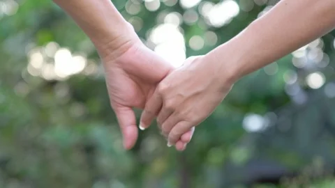 Close-up of hands joining together on bokeh background. Stock Footage 117992798