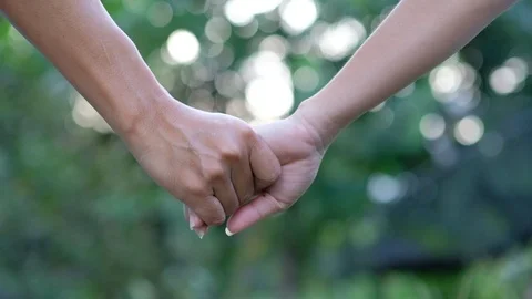 Close-up of hands joining together on bokeh background. Stock Footage 118074350