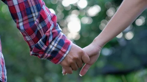 Close-up of hands joining together on bokeh background. Stock Footage 118074360