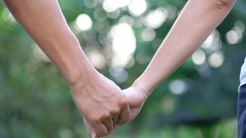 Close-up of hands joining together on bokeh background. Stock Footage 118074517