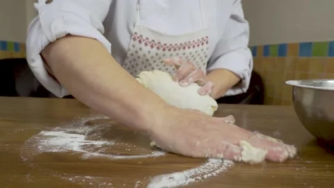Close - up hands knead the dough on the table at home. Close-up of a woman with Stock Footage 140060073