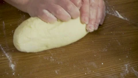 Close - up hands knead the dough on the table at home. Close-up of a woman with Stock Footage 140060089