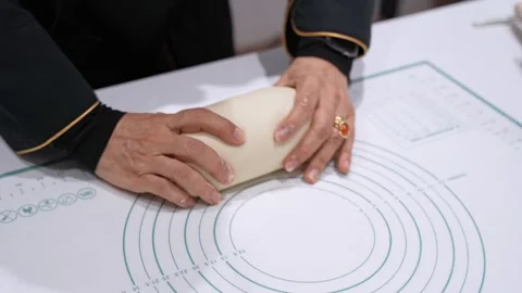 Close Up Hands Kneading Bread Dough on Pastry Mat During Indoor Home Baking Stock Footage 332069485