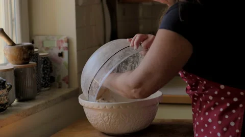 Close up of hands kneading sourdough bread, streaching the dough in bowl. Stock Footage 142358443