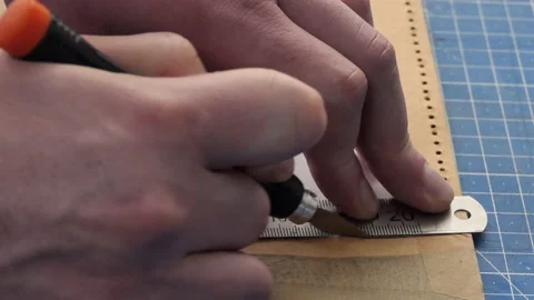 Close-up Of Hands, Knife Are Cutting Gently Line in Leather, Handmade. A male Stock Footage 178585951