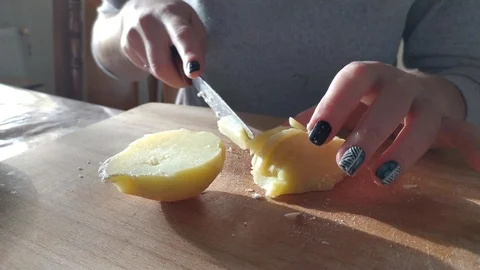 Close-up. hands with a knife cut boiled potatoes. Stock Footage 121003251