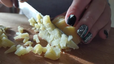Close-up. hands with a knife cut boiled potatoes. slicing potatoes for a salad. Stock Footage 121003296