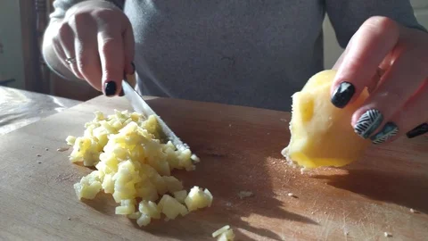 Close-up. hands with a knife cut boiled potatoes. slicing potatoes for a salad. Stock Footage 121003304