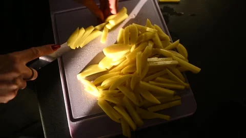 Close-up of hands with knife cutting fresh potatoes. Stock Footage 265906501