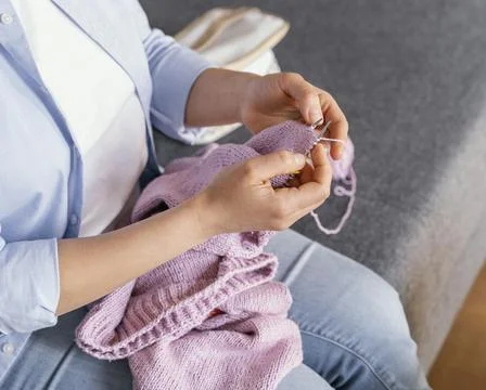 Close up hands knitting indoors Stock Photos