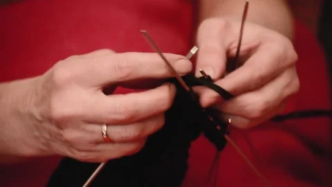 Close-up hands with knitting needles, beautiful woman knits Stock Footage 84842070