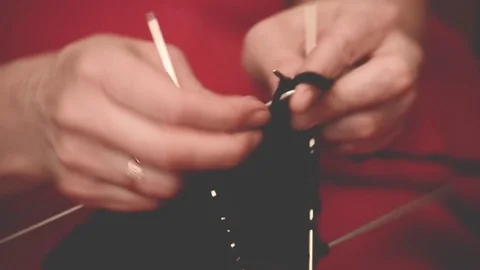 Close-up hands with knitting needles, beautiful woman knits Stock Footage 84842443