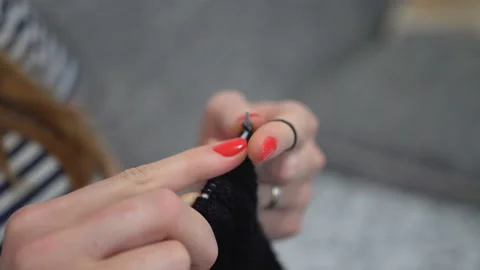 Close-up hands with knitting needles, beautiful pregnant woman knits Stock Footage 104020203