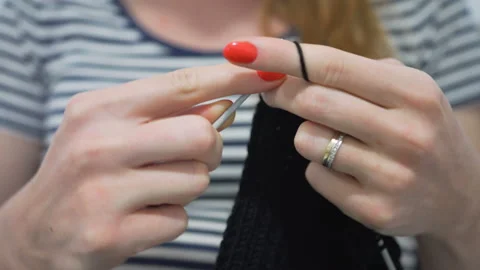 Close-up hands with knitting needles, beautiful pregnant woman knits Stock Footage 104021492