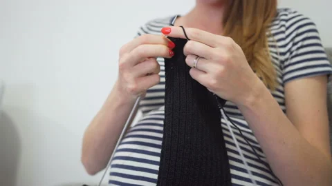 Close-up hands with knitting needles, beautiful pregnant woman knits Stock Footage 104025900