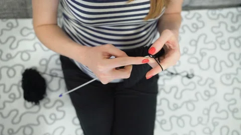 Close-up hands with knitting needles, beautiful pregnant woman knits Stock Footage 104028526