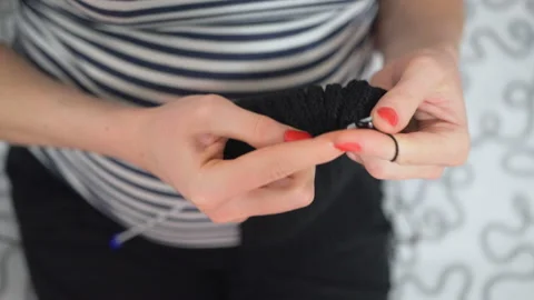 Close-up hands with knitting needles, beautiful pregnant woman knits Stock Footage 104031696