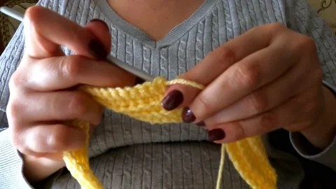 Close-Up Hands With Knitting Needles, Young Woman Knits Woolen Scarf Stock Footage 146923230